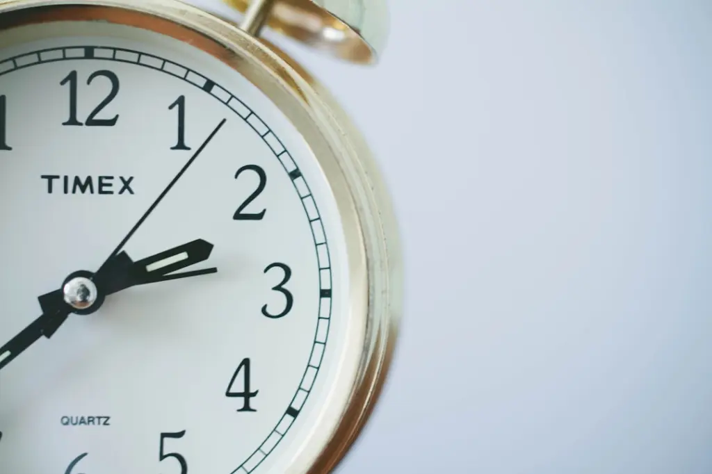 round Timex analog clock at 2:33 by Sonja Langford