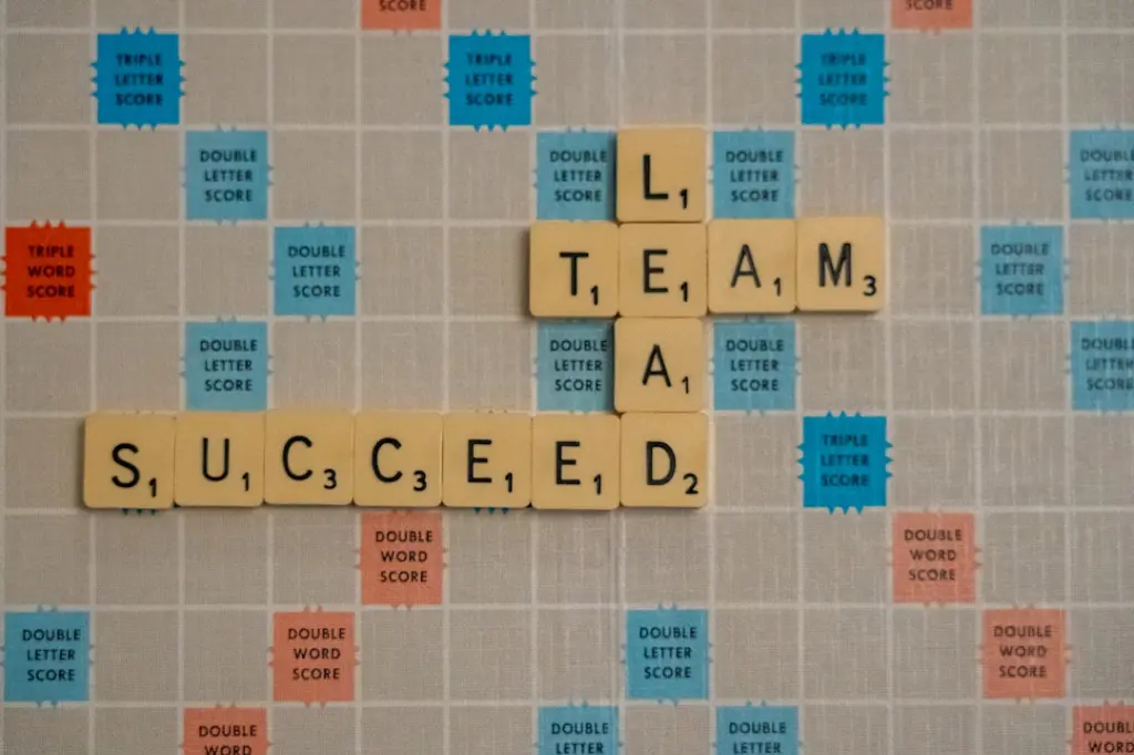 scrabbled scrabble tiles with words on them by Nick Fewings